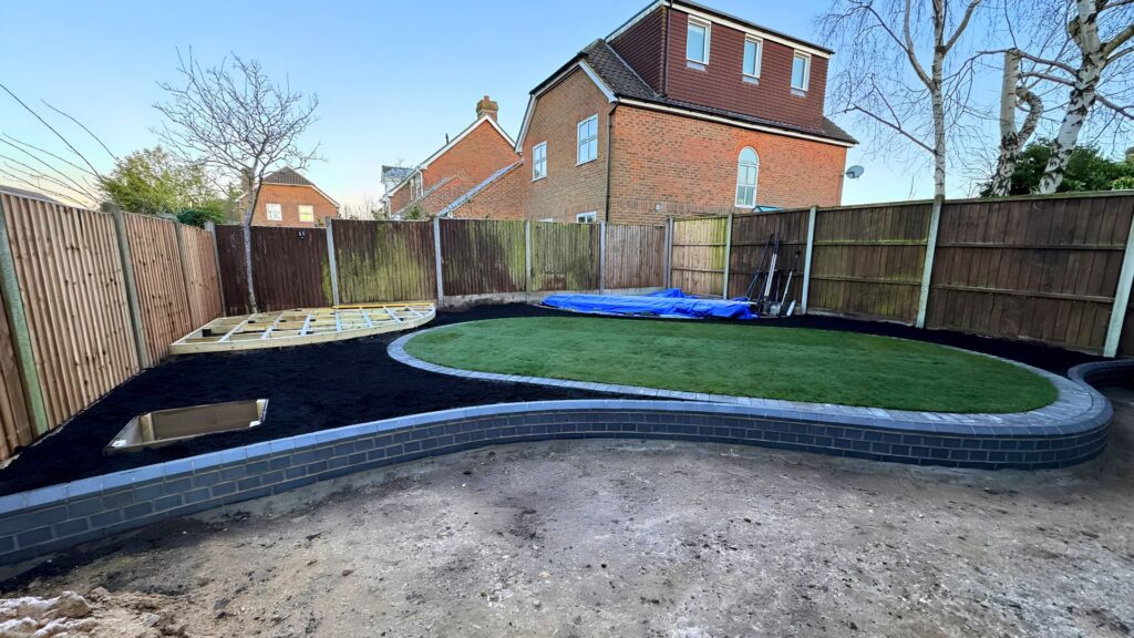 Construction in progress shaping the curved lawn