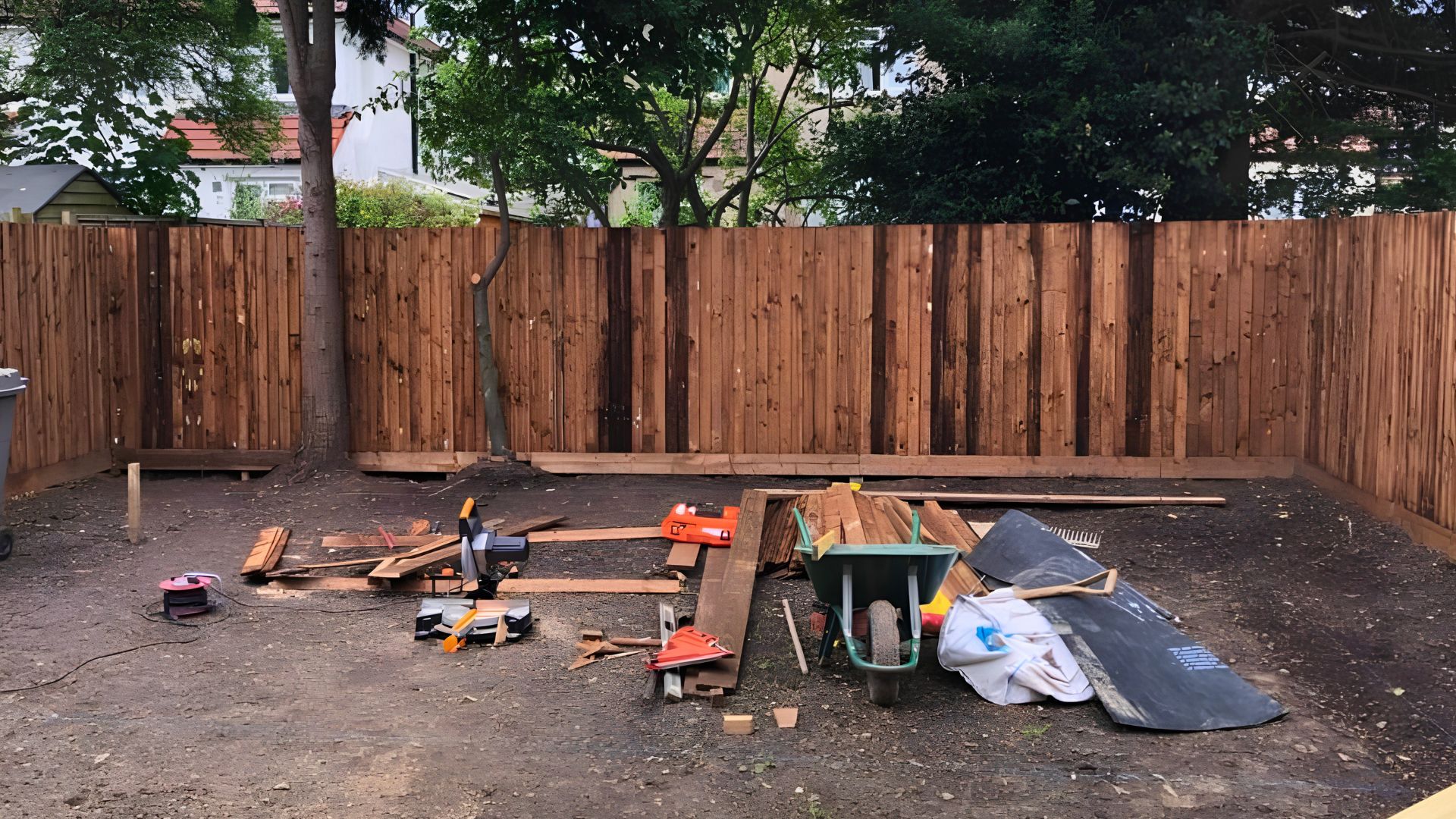 Garden landscaping during construction — fencing and groundwork stage