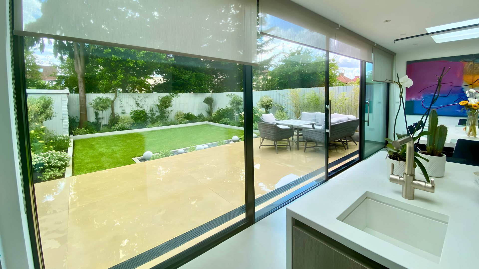 Kitchen sliding doors opening onto contemporary rear garden, indoor-outdoor living
